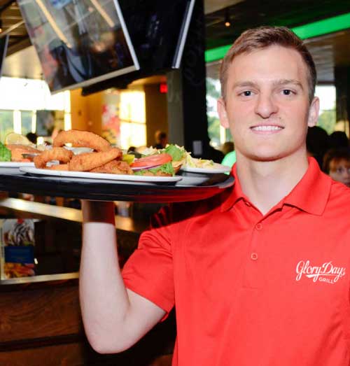 Glory Days server with plate of food in hand.