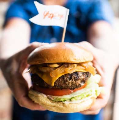 Person holding Glory Burger.