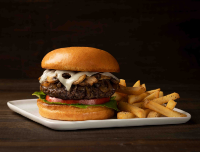 Fresh grilled burger topped with swiss cheese and mushrooms