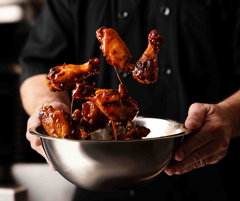 Glory Days Wings being tossed by the Chef