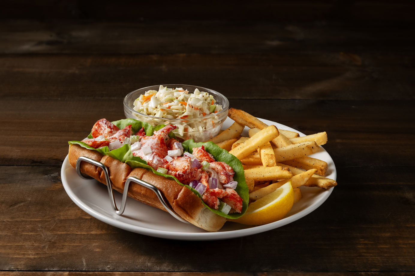 lobster roll with a side of fries and coleslaw